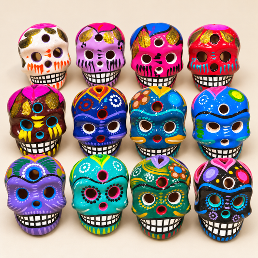 All twelve Medium hand-painted ceramic sugar skull color and design options on a warm ivory studio surface.