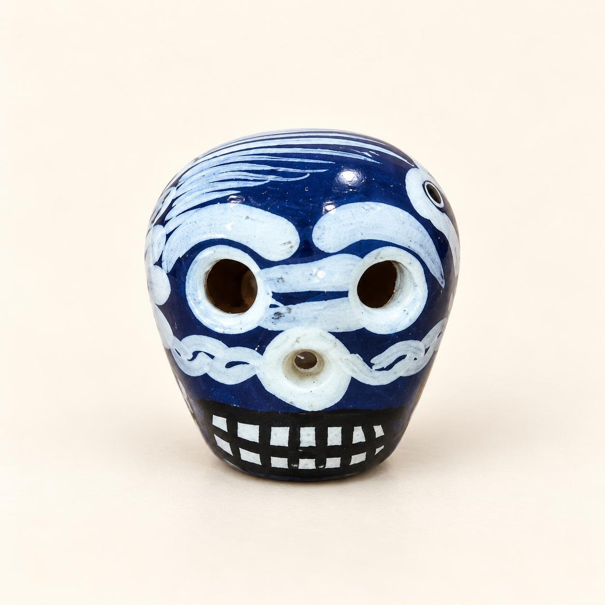 Dark blue XSM hand-painted ceramic sugar skull, approximately 1 inch, made in Mexico